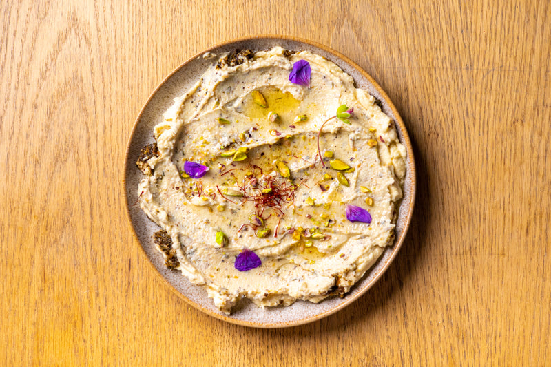 A close-up of a delicious recipe prepared with argan oil, showcasing vibrant ingredients and the rich, golden oil drizzled over the dish, adding a Moroccan touch.