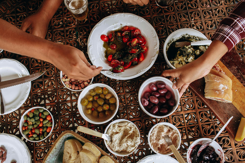 A joyful family gathering around the dinner table, savoring a meal enhanced with the rich flavor of premium argan oil, a true taste of Morocco.