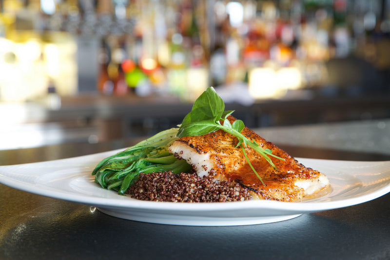 A close-up of a delicious recipe prepared with argan oil, showcasing vibrant ingredients and the rich, golden oil drizzled over the dish, adding a Moroccan touch.